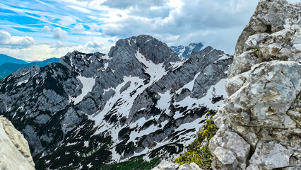 Obraz premium Panoramic views on the sharp and rocky mountain peaks of the Kamnik Savinja Alps in Carinthia, border Austria, Slovenia. Mountaineering. Freedom wanderlust hiking concept. Look at Vellacher Kotschna