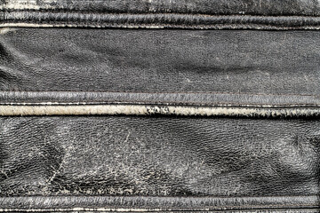 Texture of shabby leather with seams.