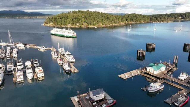 Cinematic 4K aerial drone footage of the Port and town of Friday Harbor with the arriving ferry, terminal, commercial zone, Brown Island in the San Juan Islands