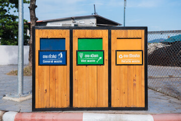 Trash bins with sorted garbage. Various kinds of trash on footpath in outdoors.