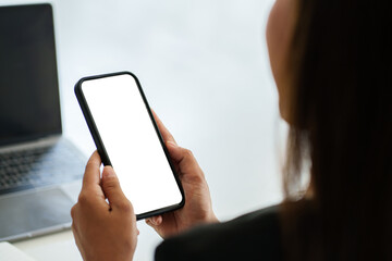 A Woman hand holding smartphone device with blank screen. Blank screen for your advertising.
