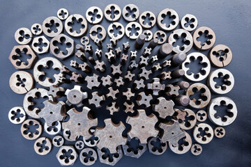 Taps and dies for metal threading. Tools for cutting external and internal threads, close-up.Taps and dies for metal threading. Tools for cutting external and internal threads, close-up.