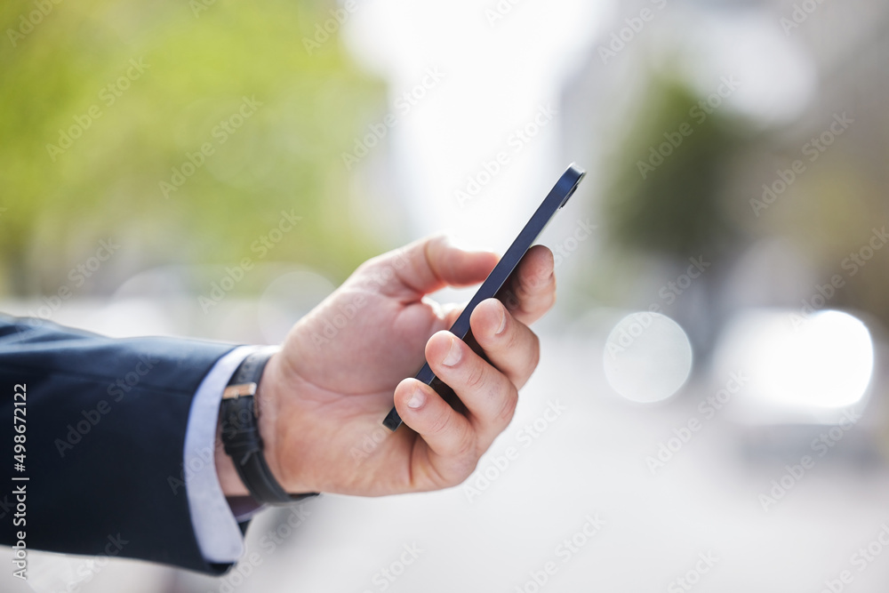Poster step aside. cropped shot of an unrecognizable businessman using his cellphone outside.