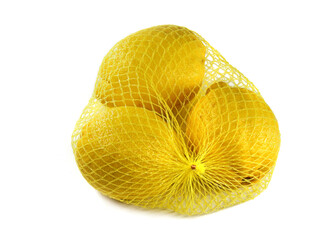 fresh lemons in a yellow net bag isolated on white background