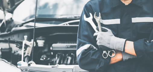 Hand of car mechanic with wrench. Auto repair garage. mechanic w