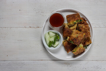 Martabak telur, Indonesian street food. fried wrap filled with eggs,minced meat, and vegetables.