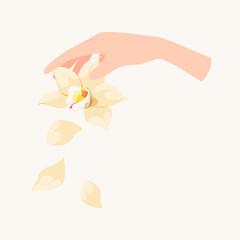 A woman's hand with a flower and orchid petals.
