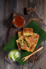Martabak telur, Indonesian street food. fried wrap filled with eggs,minced meat, and vegetables.
