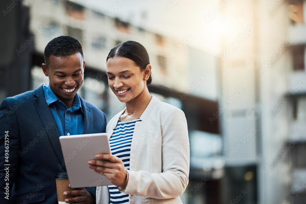Poster chasing after success with the best connection. shot of two businesspeople using a digital tablet in