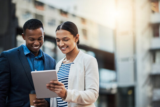 Chasing After Success With The Best Connection. Shot Of Two Businesspeople Using A Digital Tablet In The City.