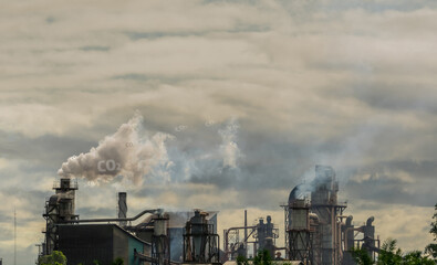 Fototapeta na wymiar CO2 emissions. CO2 greenhouse gas emissions from factory chimneys. Carbon dioxide gas global air climate pollution. Carbon dioxide in earths atmosphere. Greenhouse gas. Smoke emissions from chimneys.