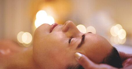 Obraz na płótnie Canvas Getting rid of all the tension. Closeup shot of a beautiful young woman enjoying a head massage at a beauty spa.