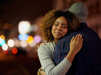 I feel so safe in his arms. Cropped shot of a young couple out on a date in the city.