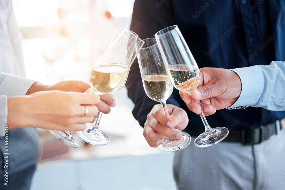 Poster lets toast to success. shot of a group of unrecognizable people toasting with wine glasses.
