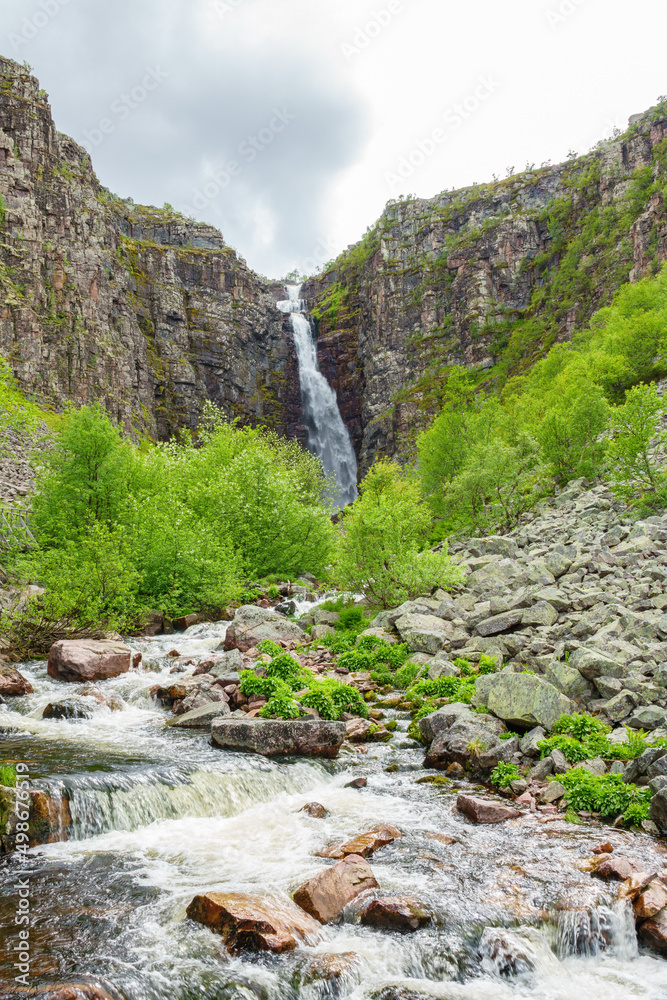 Sticker Stream of water and a waterfall on the mountain side