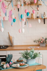 Easter pink and blue decorations on the white kitchen. Holiday spring composition