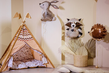 Balloons in the form of animals and wigwam on photo zone. © Dariia