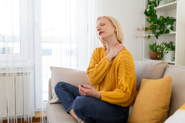 Pain in the shoulder. Upper arm pain, People with body-muscles problem, Healthcare And Medicine concept. Attractive woman sitting on the bed and holding painful shoulder with another hand.