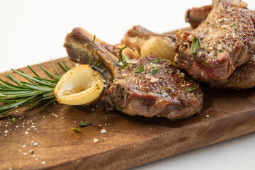 Grilled and smoked ribs with onion on a carving board
