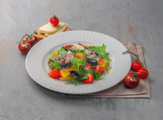 fresh vegetables salad with cheese on gray background