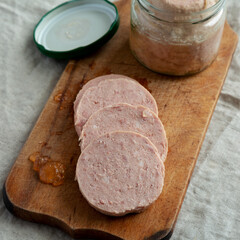Homemade Jagdwurst on a rustic wooden board, side view. Close-up.
