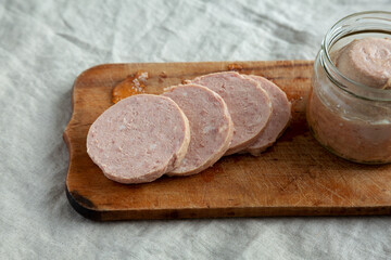 Homemade Jagdwurst on a rustic wooden board, side view. Close-up.