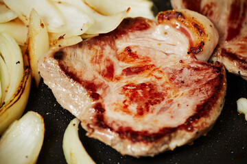 Meat and vegetables cooked in a cast iron pan