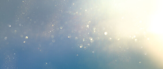 Naklejka premium background of abstract gold, blue and silver glitter lights. defocused