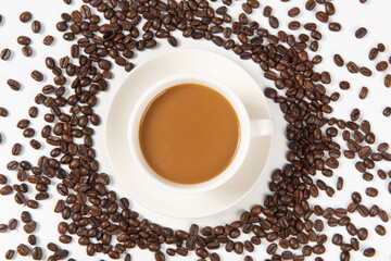a cup of coffee with coffee beans on white background