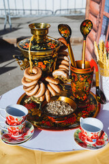 Dishes of the Russian people painting in the style of Khokhloma, samovar with boiling water, linden...