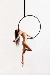 Fotobehang Fit woman performing pose on aerial hoop © photology1971