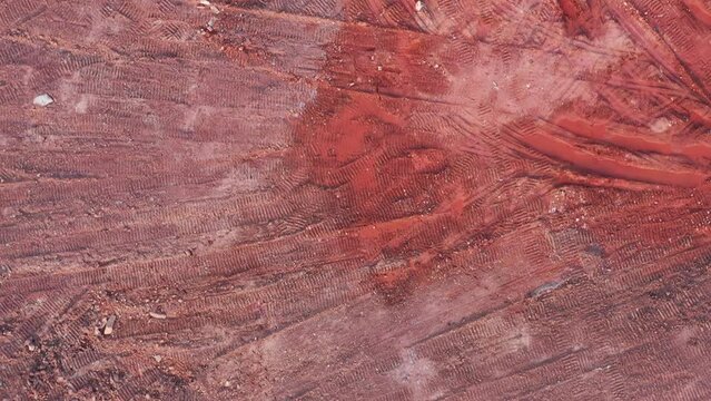 Aerial top view of red muck on construction site