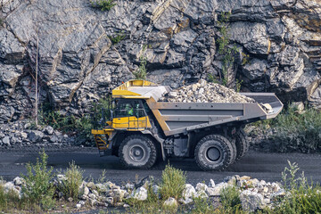 Dump truck in limestone mining, heavy machinery. Mining in the quarry.