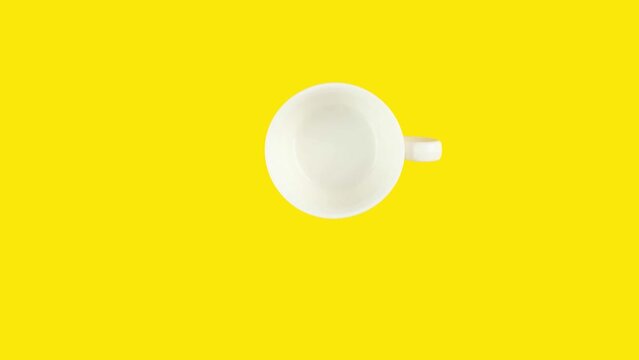 Looping stop motion animation of endless drinking of coffee from white cup on yellow background. Concept of nutrition in modern society . Copy space for your text.