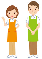 エプロンをつけた男女　挨拶する介護士　スタッフ
