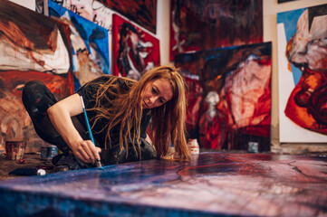 Female painter artist painting and creating her art in a creative studio