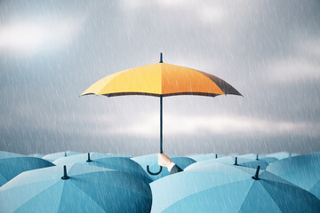 Man hand holding yellow umbrella over crowd on blurry dull sky background. Risk, protection and...