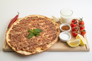 Manakish Arabian food; Lebanese food of Lahme bajeen manouche; Meat pita with veggies and yogurt  - obrazy, fototapety, plakaty