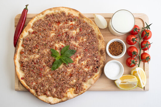 Manakish Arabian food; Lebanese food of Lahme bajeen manouche; Meat pita with veggies and yogurt 