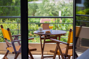 Summer. Breakfast outside by the ocean. Summer vacation in the hotel. Sandwich with coffee and orange juice. Breakfast outside in front of the ocean. Dinner. Food at the hotel. Vacation for one. Food 