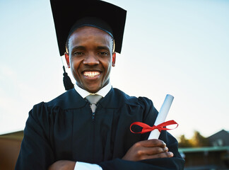 If you believe you can, you can. Portrait of a confident young man holding a diploma on graduation...