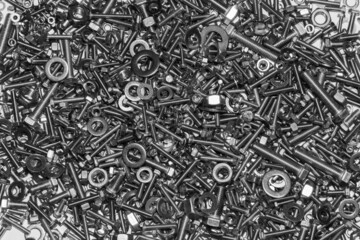 A lot of bolts nuts and washers on a white background.