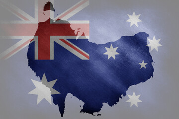The outline of the Australian border in the national colors on a grunge background