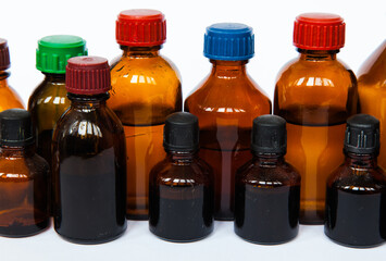 Dark brown medicine bottles on white background.