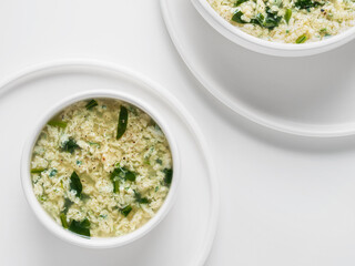 Italian cuisine. Soup Stracciatella with spinach alla Romana. Egg drop soup. Flat Lay. Horizontal....