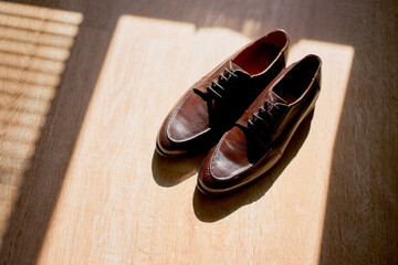 man groom wedding brown shoes close-up at the window