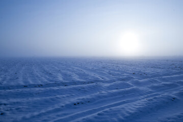 field of earth under snow in winter