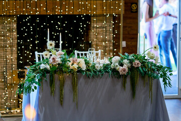 table for the bride and groom decorated with live floristry