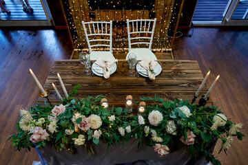 table for the bride and groom decorated with live floristry