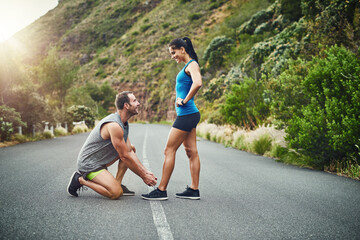He always make sure everything I do is secure. Shot of a young attractive couple training for a...